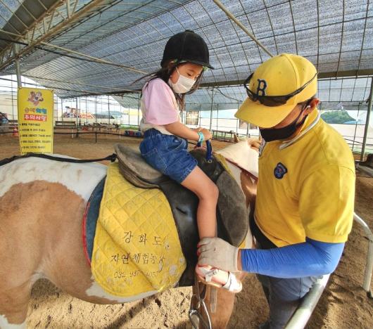 The horse uncle holding a baby