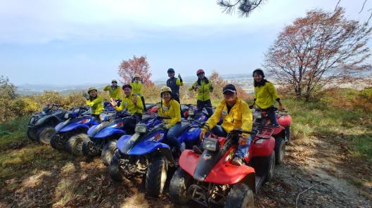 ATVs at the top of the hill in autumn
