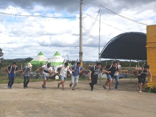 A company group playing a team game in the farm yard
